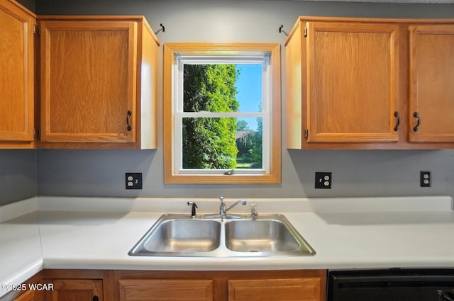 807 Centerfield Dr, Paulding, OH 45879 - kitchen with dishwasher, light countertops, and brown cabinets