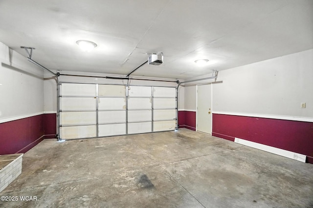 807 Centerfield Dr, Paulding, OH 45879 - garage featuring a garage door opener and baseboards