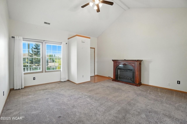 807 Centerfield Dr, Paulding, OH 45879 - unfurnished living room featuring ceiling fan, carpet, beamed ceiling, a glass covered fireplace, and high vaulted ceiling
