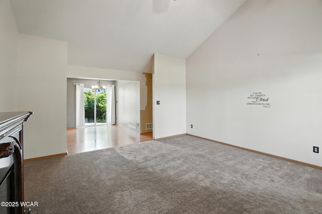807 Centerfield Dr, Paulding, OH 45879 - unfurnished living room featuring a chandelier, carpet flooring, and high vaulted ceiling