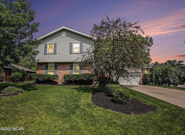 2069 High Ridge Rd, Lima, OH 45805 - view of front of property with brick siding, concrete driveway, a front lawn, and a garage