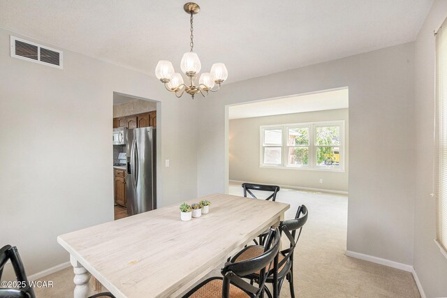 2069 High Ridge Rd, Lima, OH 45805 - dining space featuring light carpet and a chandelier
