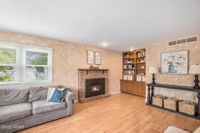 2069 High Ridge Rd, Lima, OH 45805 - living area with a textured ceiling, wood finished floors, a brick fireplace, and built in features