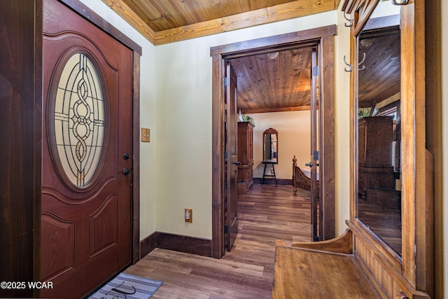 entryway featuring dark wood-style flooring, wooden ceiling, and baseboards