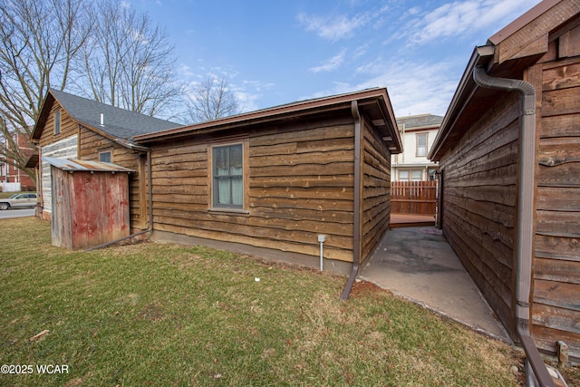 view of home's exterior with fence and a yard