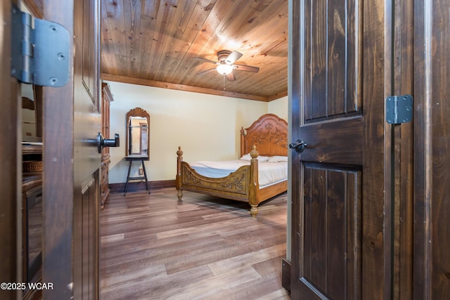 bedroom with baseboards, wooden ceiling, and light wood-style floors