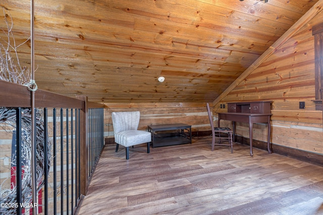 unfurnished room featuring vaulted ceiling, wooden ceiling, wood walls, and wood finished floors