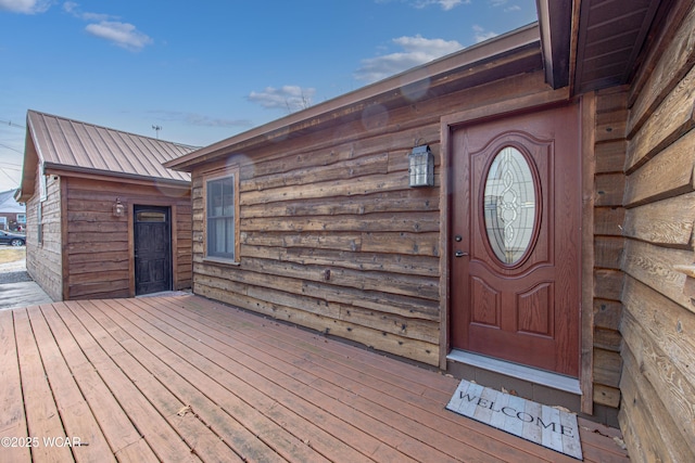 doorway to property featuring metal roof