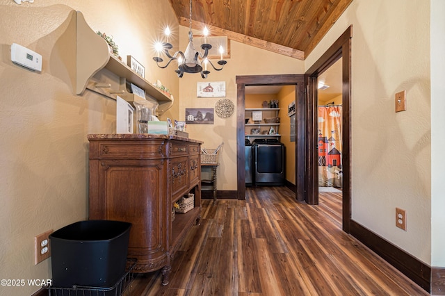 hallway featuring dark wood finished floors, lofted ceiling, washer / dryer, wooden ceiling, and baseboards