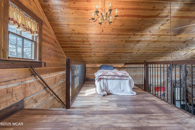 unfurnished bedroom featuring wooden walls, lofted ceiling, wood ceiling, wood finished floors, and a notable chandelier