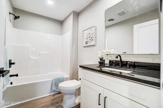 full bathroom featuring shower / tub combination, vanity, toilet, and hardwood / wood-style floors