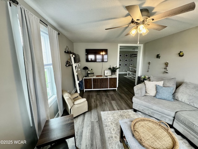 111 E Ottawa-Glandorf Rd, Ottawa, OH 45875 - living room featuring baseboards, a textured ceiling, a ceiling fan, and dark wood-style floors
