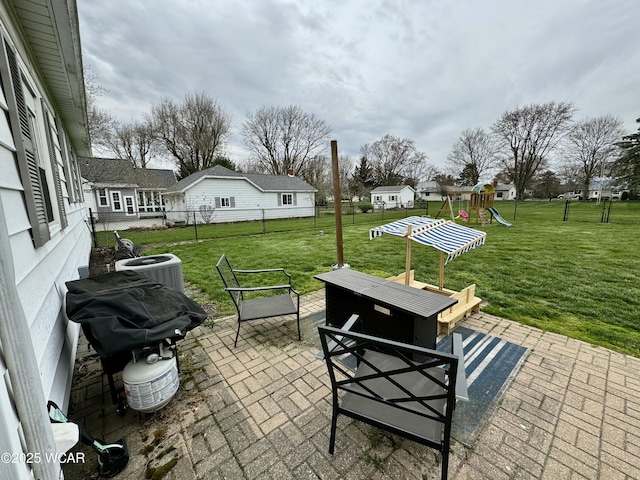 111 E Ottawa-Glandorf Rd, Ottawa, OH 45875 - view of patio with a grill, central AC, a playground, fence, and outdoor dining area