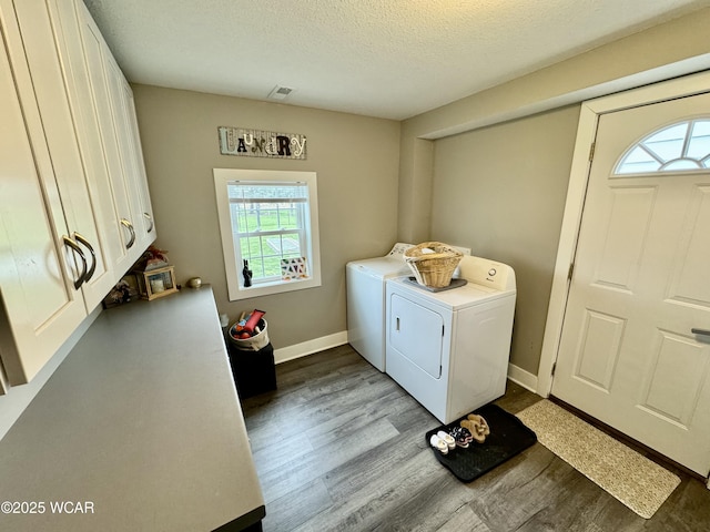 111 E Ottawa-Glandorf Rd, Ottawa, OH 45875 - laundry room with wood finished floors, a textured ceiling, cabinet space, washing machine and dryer, and visible vents