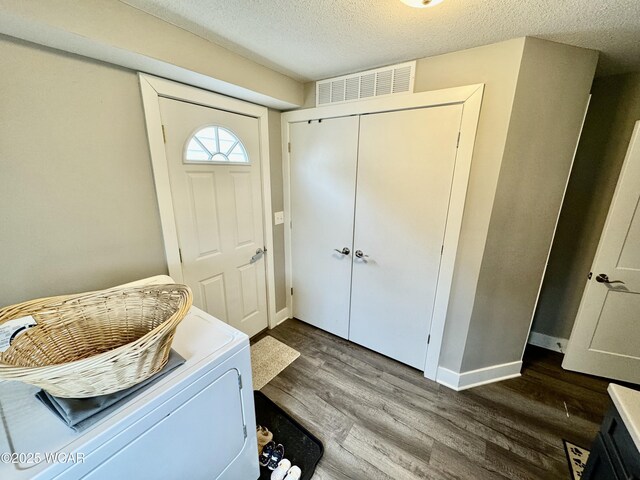 111 E Ottawa-Glandorf Rd, Ottawa, OH 45875 - entryway featuring a textured ceiling, baseboards, visible vents, wood finished floors, and washer / clothes dryer