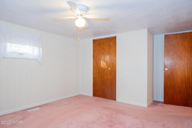 carpeted spare room with ceiling fan