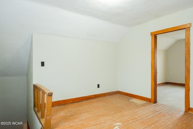 bonus room featuring lofted ceiling and light hardwood / wood-style floors