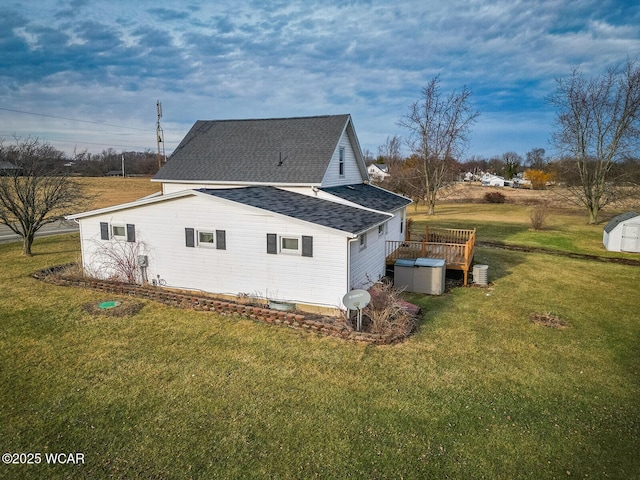 view of home's exterior with a deck and a lawn