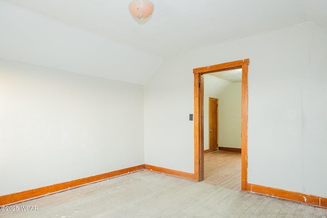 spare room with lofted ceiling