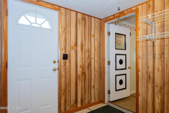 foyer featuring wooden walls