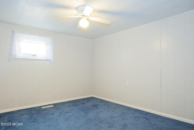 carpeted spare room featuring ceiling fan