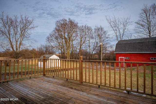 deck featuring a yard and an outdoor structure