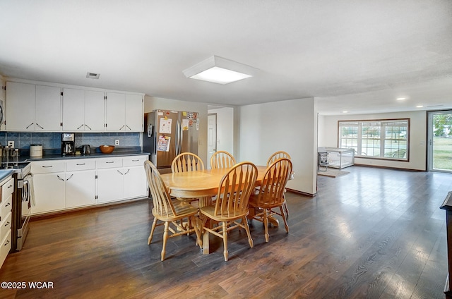 dining space with dark hardwood / wood-style floors