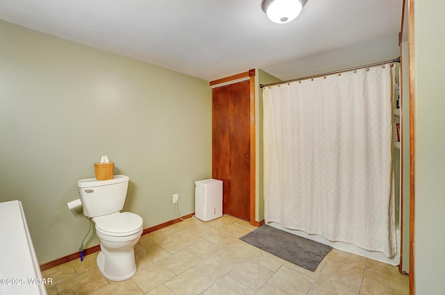 bathroom featuring toilet and tile patterned flooring