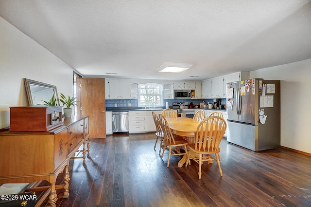 dining area featuring dark hardwood / wood-style floors and sink