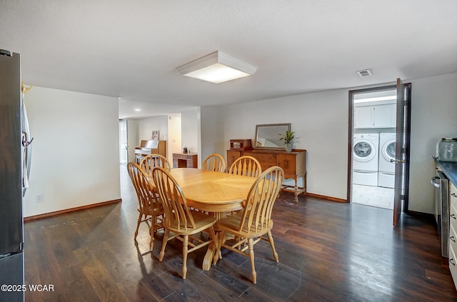 dining room with dark wood-type flooring and washer and clothes dryer