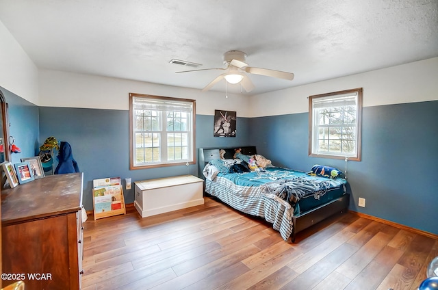 bedroom with hardwood / wood-style flooring and ceiling fan