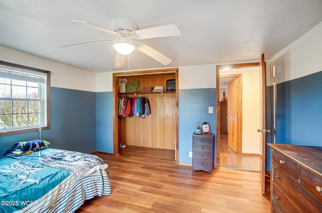 bedroom with ceiling fan, a closet, and light wood-type flooring