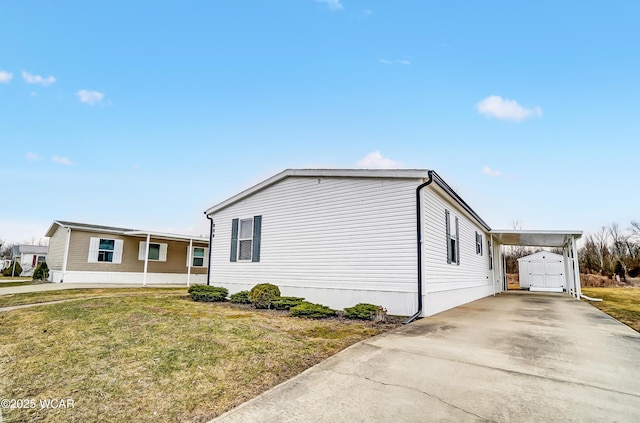 view of property exterior featuring an outbuilding, concrete driveway, and a lawn