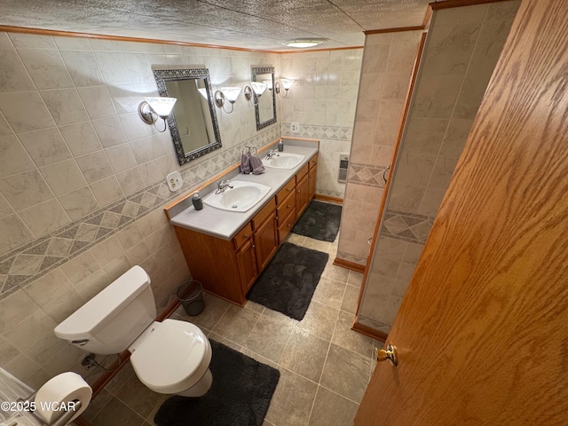 242 S Main St, Ottawa, OH 45875 - full bath with tile walls, double vanity, tile patterned floors, and crown molding
