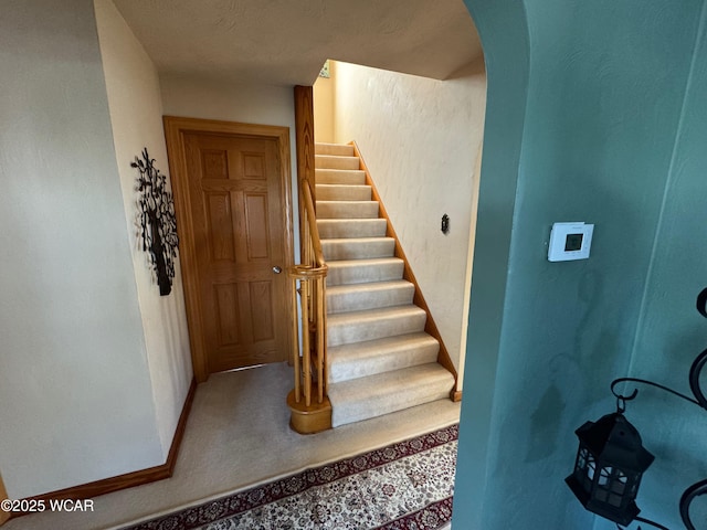 242 S Main St, Ottawa, OH 45875 - stairs with arched walkways and carpet flooring