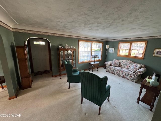 242 S Main St, Ottawa, OH 45875 - carpeted living area with arched walkways, a textured ceiling, and ornamental molding