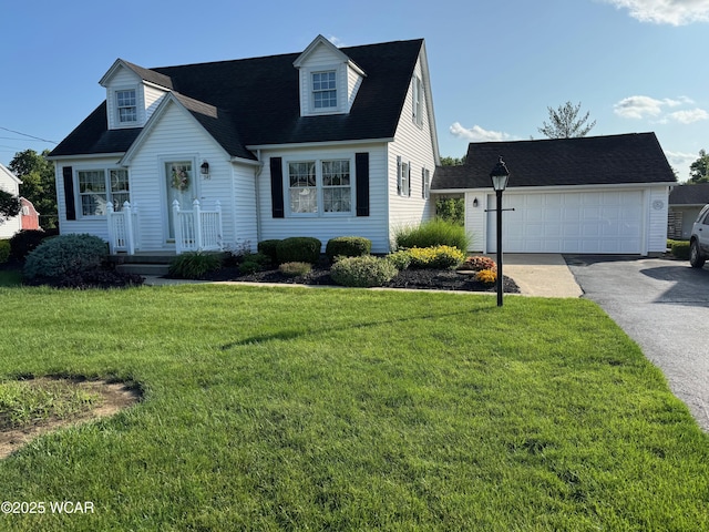 242 S Main St, Ottawa, OH 45875 - cape cod house with a front lawn, a shingled roof, a detached garage, and an outdoor structure