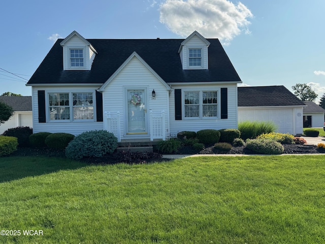242 S Main St, Ottawa, OH 45875 - new england style home featuring a front lawn and a garage