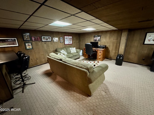 242 S Main St, Ottawa, OH 45875 - living area featuring a desk, a drop ceiling, wood walls, and light colored carpet