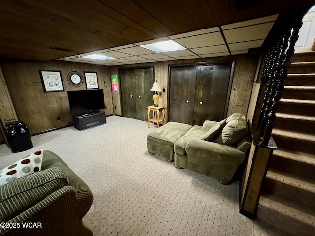 242 S Main St, Ottawa, OH 45875 - living area featuring stairs, wood walls, and carpet