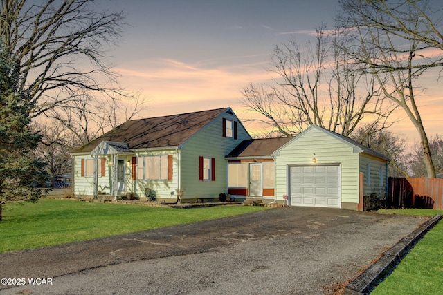 view of front of house featuring a garage and a lawn