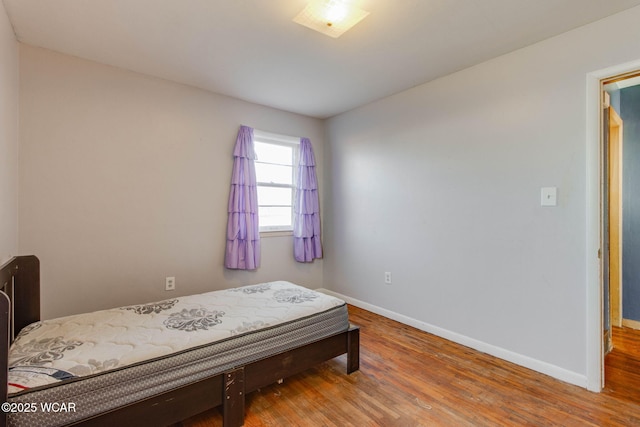 bedroom with hardwood / wood-style floors