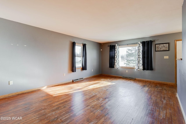 unfurnished room with hardwood / wood-style floors