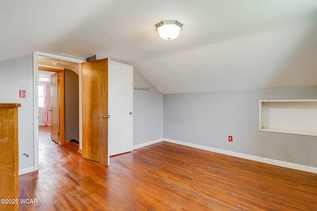 bonus room with lofted ceiling and wood-type flooring