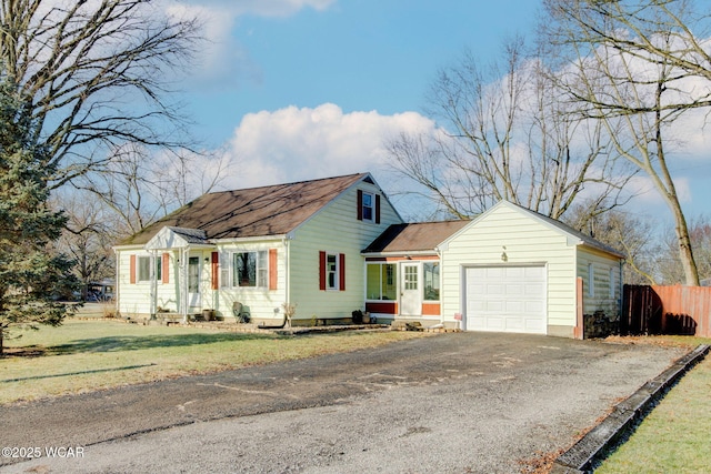 view of front of property with a garage and a front lawn