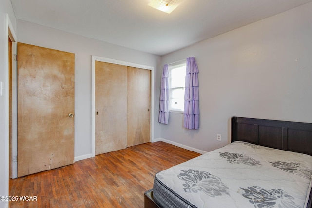 bedroom with hardwood / wood-style floors and a closet