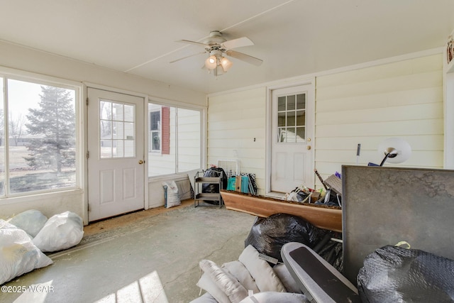 sunroom / solarium featuring ceiling fan