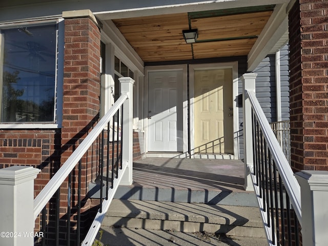 property entrance featuring brick siding