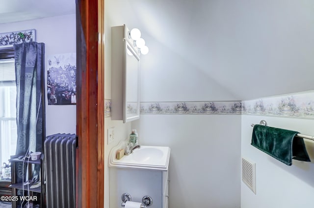 bathroom featuring vanity and radiator heating unit