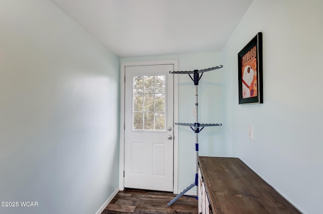 doorway to outside with dark wood finished floors and baseboards